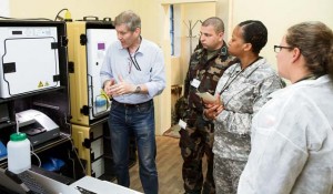 From left, French Brig. Gen. Daniel Parzy, chief medical officer at the Armed Forces Biomedical Research Institute in Marseille, France, instructs 1st Lt. Csaba Pereszlenyi, a member of the Hungarian Defense Forces medical center in Budapest; U.S. Army Capt. Chana L. Mason, a nuclear medical science officer for the 773rd Civil Support Team, 7th Civil Support Command; and Polish 1st Lt. Joanna Siedlecka, an officer with the medical prevention team assigned to the Epidemiological Response Center Military Service of the Polish armed forces in Warsaw, Poland, on the features of a portable lab and how to operate it in order to assist the Defense Threat Reduction Agency in testing the new system during the Transatlantic Collaborative Biological Resiliency Demonstration BIOSAFETY 2013 Workshop June 26.