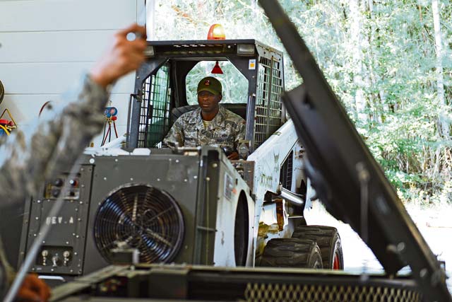 Photo by Airman 1st Class Michael Stuart  Staff Sgt. Patrick Robinson, 435th Construction and Training Squadron heating ventilation air condition instructor, moves a field-deployable, environmental control unit during a seven-day heating, ventilation and air conditioning course on Ramstein Air Base, Germany, Aug. 6, 2014. The FDECU is a five-ton air conditioning unit used to heat and cool a variety of military shelter systems such as personnel tents and communications facilities at deployed locations. 
