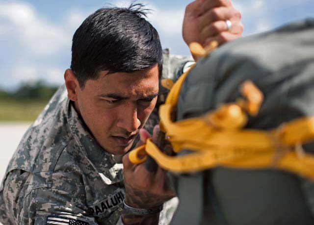Photo by Senior Airman Damon KasbergU.S. Army Sgt. David H. Pa’aluhi, paratrooper from the 1st Battalion, 503rd Infantry Regiment, 173rd Airborne Brigade, rigs a Bulgarian soldier’s parachute during Steadfast Javelin II Sept. 2, 2014, on Ramstein.