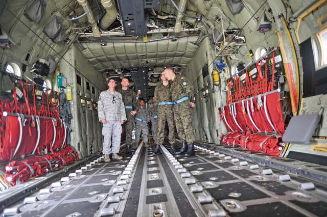 Photo by Senior Airman Aaron-Forrest WainwrightRamstein Master Sgt. Jason Carey, 86th Aircraft Maintenance Squadron production superintendent, explains the multiple functions of the C-130J Super Hercules to Warrant Officer 1st Class Krzysztof Gadowski (second left), Polish chief master sergeant of the air force, and his staff.