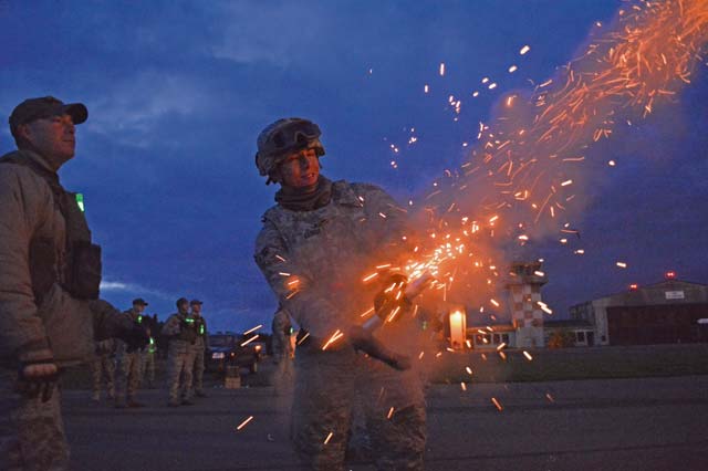 Airman 1st Class David Vasquez, 355th Security Forces Squadron Creek Defender course trainee, fires a slap flare during a night combat tactics class Tuesday in Baumholder. Vasquez was part of a 98-student class that underwent training to prepare them for deployed conditions around the world.