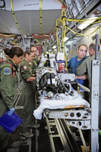 A specialized medical team ensures a patient is safe and ready for takeoff  July 10 on Ramstein. An active-duty Air Force crew made history while flying specialized medical teams and their patient requiring medical equipment never before used onboard a transatlantic mission.