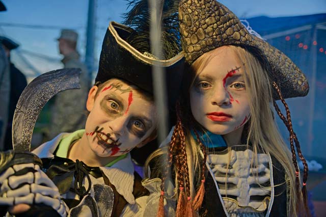Zachary, 6, and Annabella Seidl, 9, guard their zombie pirate tent hideaway during the 2013 Halloween Trunk-or-Treat Oct. 31 at Donnelly Park on Ramstein. Trunk-or-Treat featured goblins, ghouls, monsters, minions, aliens and dinosaurs, as well as food, games, movies, costume contests and trunks full of candy for eager trick-or-treaters. 