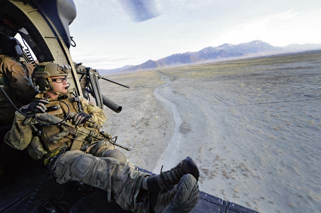 Staff Sgt. George Reed, 83rd Expeditionary Rescue Squadron pararescueman, watches the terrain during a mission outside of Bagram Airfield, Afghanistan, March 12, 2013. The 83rd ERQS Guardian Angel comprises three career fields: the CRO (combat rescue officer), the PJ (pararescuemen) and SERE (survival, evasion, resistance, escape Airmen).