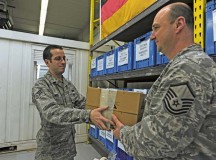 Senior Airman Andrew Mero, 86th Logistics Readiness Squadron individual equipment element technician, issues Master Sgt. Kenneth Pruett, 86th LRS unit deployment manager, boots for a deploying troop Jan. 21 on Ramstein.