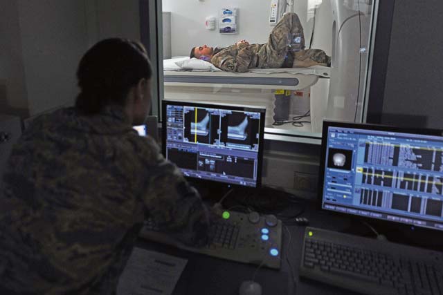 Staff Sgt. Brandy Bisson, diagnostic imagery computerized tomography scan technician, checks the CAT scan imagery of U.S. Army Sgt. Karl Berlinger’s foot Feb. 12 at Landstuhl Regional Medical Center. Berlinger received treatment for his injuries at LRMC within one hour of arrival from Bagram Air Field, Afghanistan.