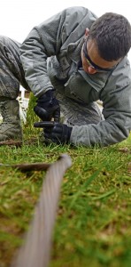 Staff Sgt. Samuel Walker, 435th Contingency Response Group specialist, ties a copper wire around a metal post to provide electricity to a tent during indoctrination training Feb. 24 on Ramstein.