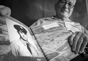 Photo by Airman Dymekre AllenPeter Karpawitz-Godt, AAFES clothing issue military management clerk, looks at his basic military training photograph and reminisces about the  past March 18 on Ramstein.