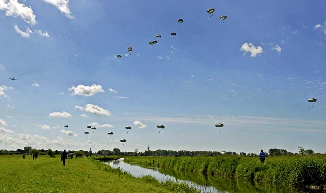 Photo by Staff Sgt. Sara KellerParatroopers jump onto the Iron Mike drop zone June 8 in Sainte-Mere-Eglise, France. More than 600 U.S., German, Dutch and French service members jumped to honor the paratroopers who jumped into Normandy on D-Day. The event was one of several commemorations of the 70th anniversary of D-Day operations conducted by Allied forces during World War II June 5 to 6, 1944. More than 650 U.S. military personnel have joined troops from several NATO nations to participate in ceremonies to honor the events at the invitation of the French government.