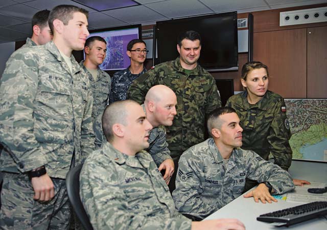 Members of the 21st Operational Weather Squadron take an opportunity to learn more about local weather patterns with 2nd Lts. Monika Kaczanowska and Daniel Kowalczyk, Polish armed forces meteorological and oceanographic officers, Nov. 14 on Kapaun Air Station. The 21st OWS showed the two Polish armed forces members around the U.S. European Command and U.S. Africa Command weather systems and operations.