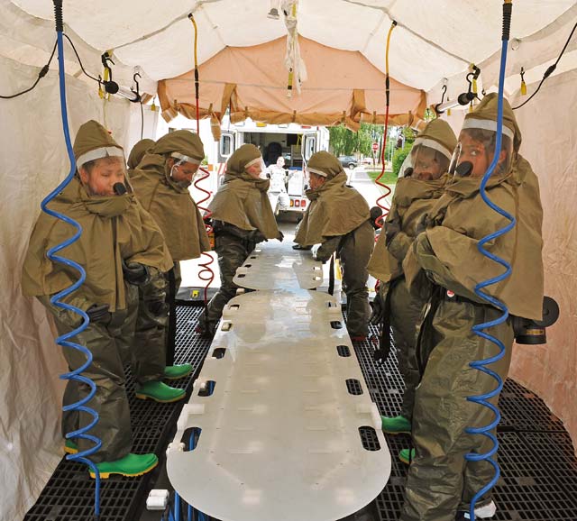 Photo by Airman 1st Class Dymekre AllenAirmen from the 86th Medical Group process a simulated chemical decontamination checkpoint station during training Monday on Ramstein. The medical group conducts training on base to test the group’s readiness. 