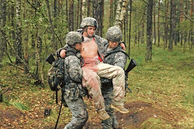 Photo by Sgt. 1st Class Randall JacksonFirst Lt. Jorge Delgado (left), assigned to the 212th Combat Support Hospital, evacuates a casualty with the help of a support Soldier during the Expert Field Medical Badge test Sept. 13. The EFMB test is the utmost challenge to the professional competence and physical endurance of the military medical professional. 
