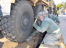 Soldiers from the 5th Battalion, 7th Air Defense Artillery Regiment, 10th Army Air and Missile Defense Command brace a vehicle on a railcar during a logistical exercise Oct. 16 on Rhine Ordnance Barracks.
