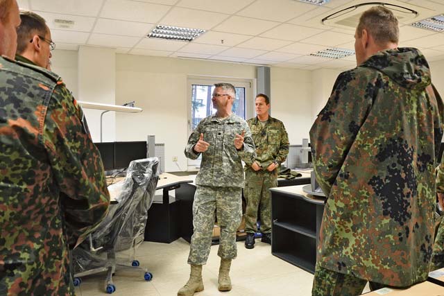 Lt. Col. George Brown, U.S. Army Garrison Rheinland-Pfalz’s emergency services director, briefs visiting German military police soldiers at the garrison’s new fire alarm control center at Rhine Ordnance Barracks.