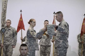 Lt. Col. Lisa Bartel, commander of the 5th Battalion, 7th Air Defense Artillery Regiment, 10th Army Air and Missile Defense Command, and Command Sgt. Maj. Stephen Burnley, the senior enlisted Soldier for 5-7 ADA, uncase the unit colors recently at a transfer of authority ceremony in Gaziantep, Turkey.