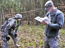 Sgt. Noel Phelps (left), parachute rigger with the 21st Theater Sustainment Command’s 5th Quartermaster Company (Riggers), 21st Special Troops Battalion, catches his breath while Sgt. Matthew Langton, 5th QM Co. parachute rigger, grades the results of the land navigation portion of the Best Warrior Competition.