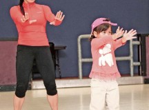 Insanity fitness instructor Renee Grande participates in Zumba class with her daughter, Madeline, April 21 at the Vogelweh Crossroads Skating Rink. The class welcomes both young children and their parents.