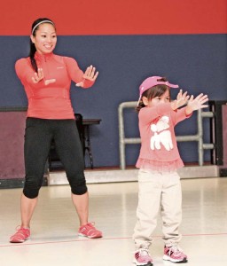 Insanity fitness instructor Renee Grande participates in Zumba class with her daughter, Madeline, April 21 at the Vogelweh Crossroads Skating Rink. The class welcomes both young children and their parents.