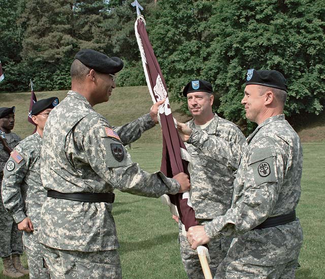 Courtesy photoMaj. Gen. Brian C. Lein, deputy surgeon general and deputy commanding general for operations, U.S. Army Medical Command, passes the Europe Regional Medical Command colors to Brig. Gen. Norvell V. Coots, the new ERMC commander and U.S. Army Europe command surgeon, as Col. John P. Collins, outgoing ERMC commander and U.S. Army Europe command surgeon looks on May 22 during a change of command ceremony.