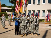 Photo by G. Patrick HarrisKathleen Y. Marin, Installation Management Command-Europe director, and Command Sgt. Maj. Jeffrey S. Hartless uncase the IMCOM-E colors during a ceremony June 6 at Sembach Kaserne. The command moved to Sembach from Heidelberg as part of the ongoing U.S. Army transformation in Europe.