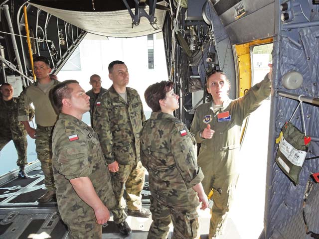Photo illustration by Lt. Col. Kevin Hettinger Tech. Sgt. Elizabeth Araujo, 86th Aeromedical Evacuation Squadron, discusses tactics with the Polish AE team May 9 at Plovdiv Air Base, Poland.