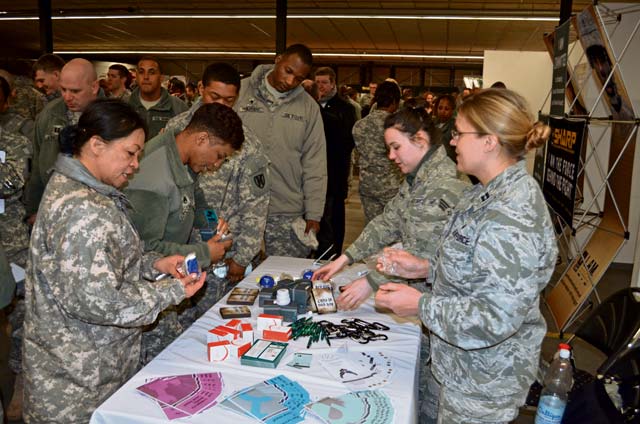 Service members from the KMC examine items from one of the many informational booths at the Sexual Harassment and Assault Response and Prevention Stand Down April 3 at Rhine Ordnance Barracks.