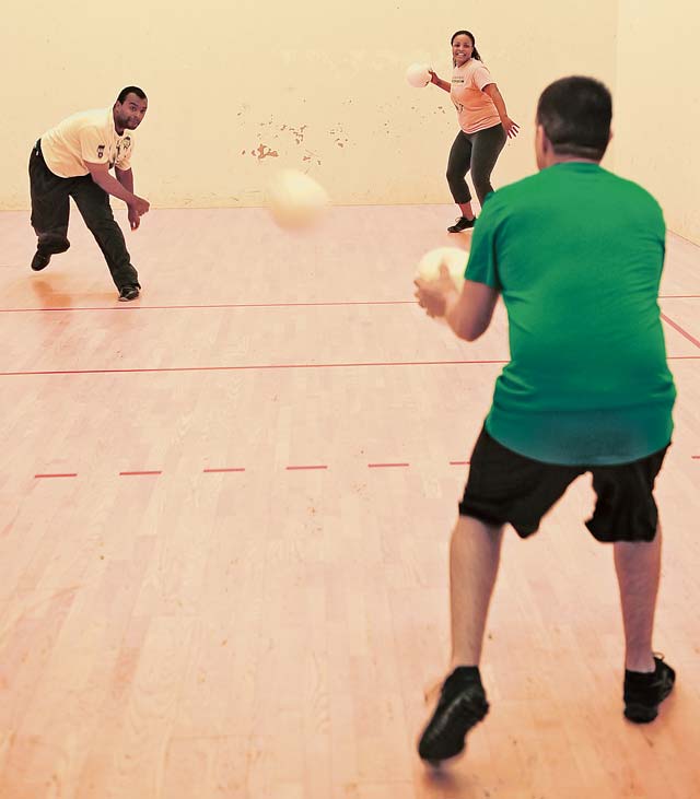 Carlos Griggs (left) and Dorian Hawkins team up on the last opponent in a dodge ball game during the 2013 Mission Support Group Sports Day Sept. 18 on Ramstein. Quarterly, the 86th MSG conducts a sports day as an opportunity for colleagues to get to know each other outside the workplace and build camaraderie.