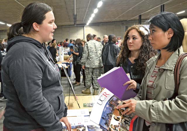 Photo by Elizabeth BehringRebeccah Steil (left), a senior at University College Roosevelt in Middelburg, the Netherlands, speaks with prospective student Madison Block (near right), a senior at Bitburg Middle-High School near Spangdahlem Air Base, and her mother, Kelli Block, at the annual Europe-wide College Night Oct. 17 at the Kaiserslautern Special Events Center on Rhine Ordnance Barracks. An estimated 1,500 ID cardholders stationed throughout Europe attended the event, which included representatives from some 80 accredited colleges and universities from the U.S. and across Europe.