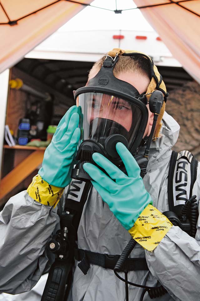 Airman 1st Class Eric Welsh, 786th Civil Engineer Squadron emergency management journeyman, dons an oxygen mask while preparing for a biological response exercise  Sept. 26 on Ramstein. Squadrons train quarterly to stay prepared for real-world situations.