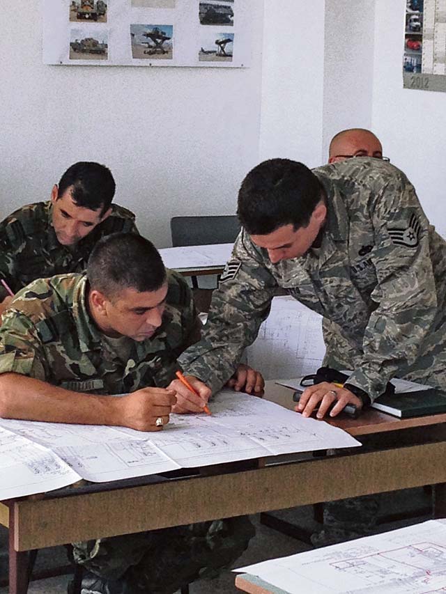 Courtesy photoStaff Sgt. Luis Devotto, 435th Air Ground Operations Wing’s Contingency Readiness Group Air Adviser Branch air adviser special vehicle maintenance, goes over the schematic of a Halvorsen Loader aircraft loader with Bulgarian Joint Forces Command members in Plovdiv, Bulgaria. Devotto and Staff Sgt. Jonathan Rasmussen, 48th Logistics Readiness Squadron transportation specialist from Royal Air Force Lakenheath, England, trained 16 members for two Bulgarian movement control teams on the operations and maintenance of a Halvorsen aircraft loader.