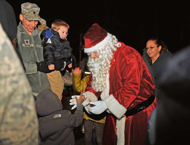 Photo by Airman 1st Class Larissa GreatwoodSanta Claus greets children during a tree lighting ceremony Dec. 1, 2014, on Ramstein. The event consisted of musical performances, the tree lighting ceremony, a meet-and-greet with Santa, and cookies and hot cocoa.