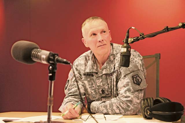 by Sgt. 1st Class Matthew ChlostaCommand Sgt. Maj. James L. Murrin, acting 21st Theater Sustainment Command senior enlisted leader and permanent 7th Civil Support Command CSM, listens to a Soldier’s query Monday afternoon in the Armed Forces Network Kaiserslautern studio. The Boston native discussed Soldier professional development and answered questions submitted by Soldiers and civi-lians during the weekly 21st TSC radio program hosted by Sgt. 1st Class Ian Camejo.