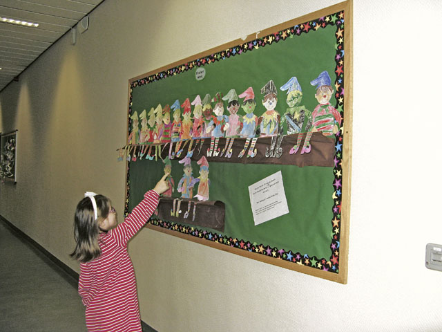 Courtesy photoElf on a ShelfA student in Madonna Rodriguez’s second grade class at Landstuhl Elementary/Middle School checks to see whose Elf on the Shelf she can find by using the descriptive words written by her classmates.