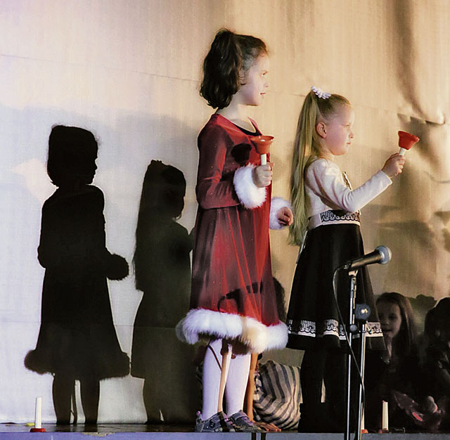 Photo by Jennifer RugeKES Holiday ShowSophie Palin and Maria Lee, second graders at Kaiserslautern Elementary  School, ring their bells during the KES Holiday Show at the Galaxy Theater. 