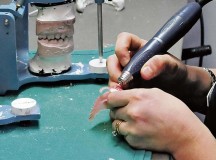 Tech. Sgt. Candice Reffitt, 86th Dental Squadron dental laboratory technician, uses a shaping tool to form a dental implant Jan. 15 on Ramstein. Reffitt instructs Airmen trainees on how to make valplast teeth.