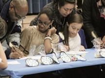 Courtesy photoAVID at RMSAdvancement Via Individual Determination seven students Kendra Bourns and Zoe Harrigan watch as their parents sign the Ramstein Middle School AVID contract for the year. As part of the program, students are required to sign a contract committing them to skills and strategies that will enhance their college readiness. More than 50 students and 15 staff members at RMS and Ramstein Intermediate School are involved in the RMS AVID program.