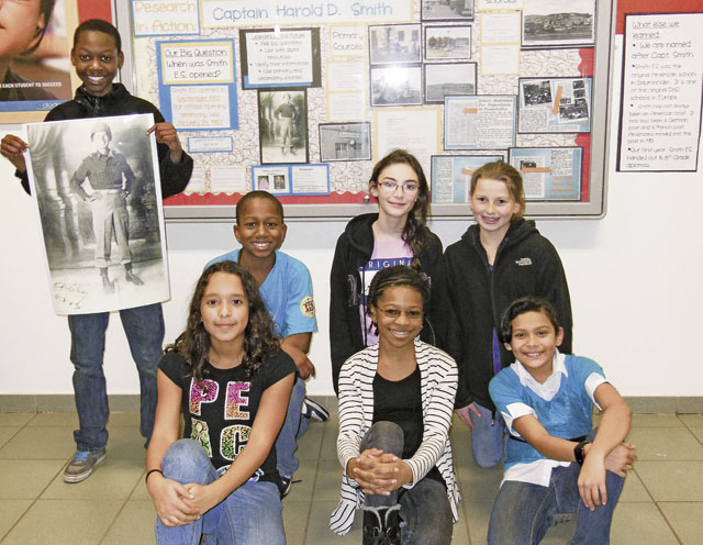 Photo by Heather MajorwitzResearch in action: learning about Captain Smith(Top row) Fedjy Calixte, Cory Byrd, Madeline Zdunich, Piper Koehler, (bottom row) Camille Airington, Alexandria Camp and Jalyn Vicencio, students at Baumholder’s Smith Elementary School, learn about Capt. Harold D. Smith, the man after whom the school is named.