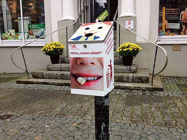 Photo courtesy of the City of KaiserslauternA machine for used chewing gum can be found next to the Stiftskirche in the center of Kaiserslautern until mid-November. Citizens are asked to dispose of their gum in the machine and not spit it on the ground, where they stick and become difficult to dispose of. The machines for used chewing gum keep the city from having to use expensive lasers to clean the streets. This idea was highlighted during a scientific idea contest. Six ideas were chosen and worked by scientists in research groups and institutes. Two more machines are set up at the corner of Schneider-  and Marktstrasse and on Fackelstrasse 38.