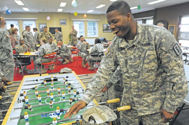 Pfc. Mario Avent, 212th Combat Support Hospital, plays foosball with fellow Soldiers during the opening of the “Ammo Shack” Monday on Miesau Ammo Depot.