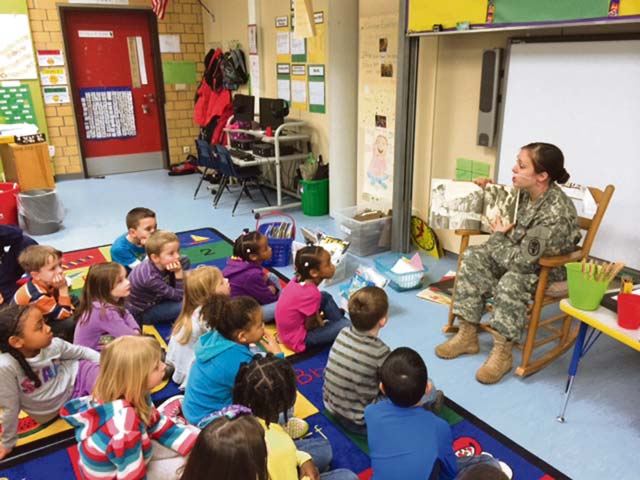 Courtesy photoStaff Sgt. Tiffany Hardenstine, equal opportunity leader at the Warrior Transition Battalion, reads to Kristine Cephus’ and Amy Hudzikiewicz’s first grade classes at Vogelweh Elementary School Feb. 13. She  volunteered to be a guest reader in celebration of African-American Heritage Month.