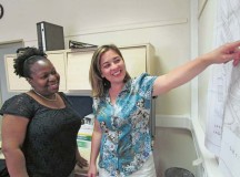 Stephanie VanDine (right), contracting officer at the 409th CSB’s Theater Contracting Center, and Miranda Lee, budget analyst with the 405th Army Field Support Brigade, review a site map as part of on-the-job training for a job shadow program with Army Sustainment Command.