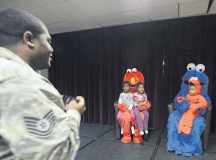 Tech. Sgt. Andre Grant, U.S. Air Forces in Europe and Air Forces Africa, takes a photo of his children with Elmo and Cookie Monster during a family night hosted by the Ramstein Community Center Sept. 22.