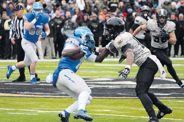 Photo by Cadet 3rd Class Alex LeeAir Force Falcons wide receiver Garrett Brown tries to elude the Army’s defense on the field  Nov. 1 at the Falcons vs. Black Knights game at the U.S. Military Academy in New York. The Air Force won, 23-6, securing the trophy for the 19th time. Brown, an academy junior, ran two catches for 54 yards and had four rushes for a total of nine yards.