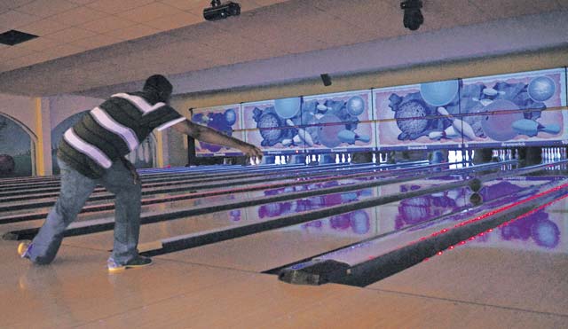 Airman 1st Class Benjamin George, 86th Vehicle Readiness Squadron, rolls a bowling ball down a lane Aug. 29 at the Ramstein Bowling Center. George and other Airmen took advantage of a free bowling event as part of the Single Airman Program Initiative.