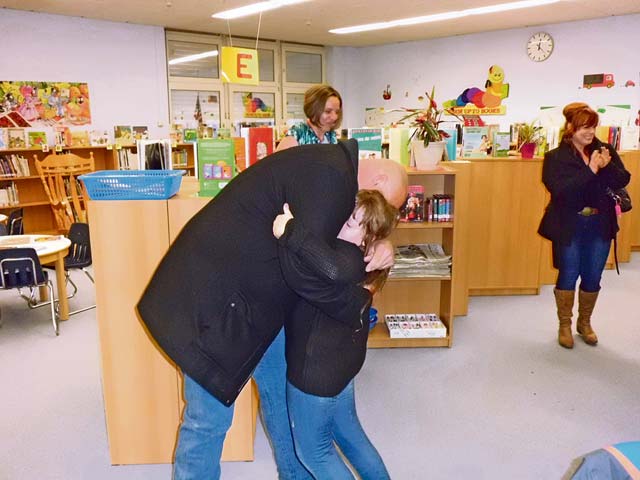 Photo by Cathy LongoRichard T. Lutter surprises his daugther, Julie Lutter, at Kaiserslautern Elementary School by returning home from Afghanistan early. Julie is in third grade at KES.
