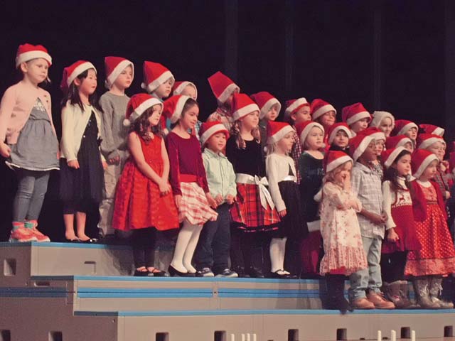 Photo by Cathy LongoKindergarten students from Kaiserslautern Elementary School sing Christmas songs during the KES Holiday Program. Their performance was a big hit, and it helped prepare the crowd for the holiday season.