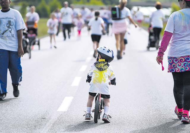A young boy rides his bike during the Keystone Color Run.