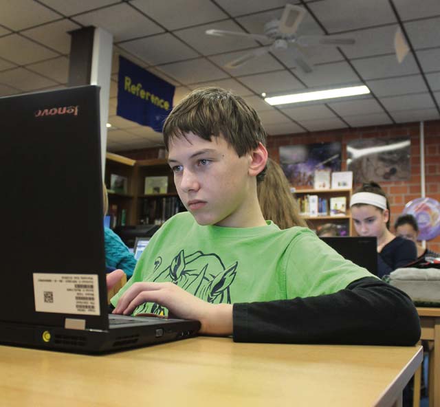 Photo by Jennifer DeverLandstuhl Elementary/Middle School eighth-grader Jesse Sawyer participates in the “Hour of Code,” an education initiative designed to get students interested in computer science.