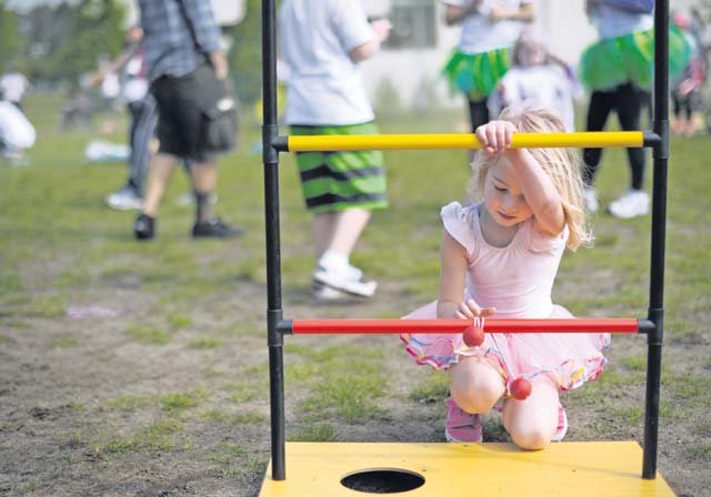 A child plays a game after participating in the Keystone Color Run with her family.
