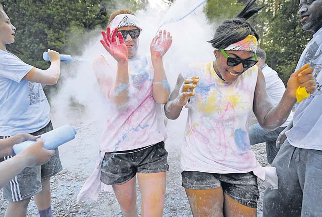 Members of Team Ramstein run through the final color station during the Keystone Color Run.